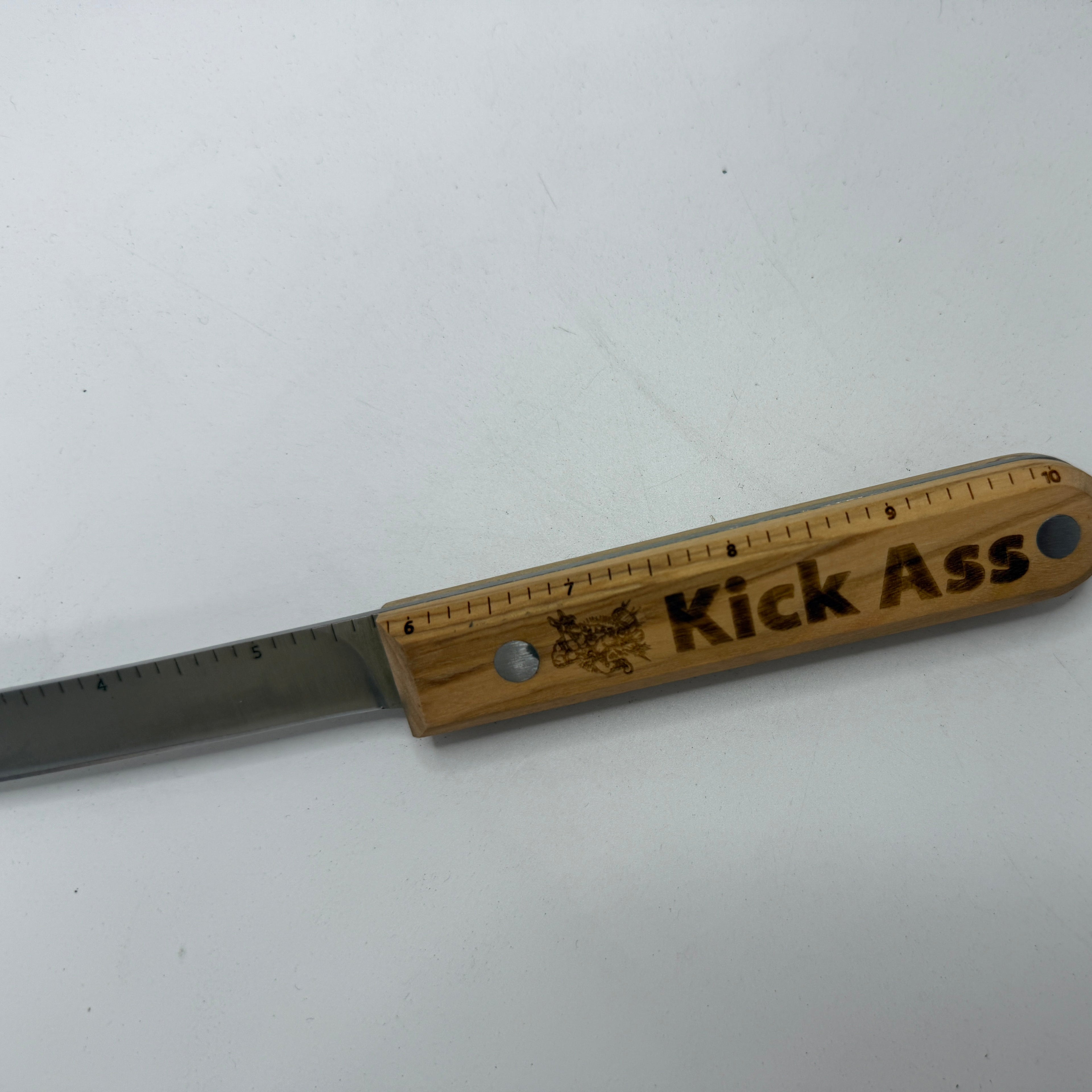 Wooden-handled Kick Ass knife with ruler inlay.
